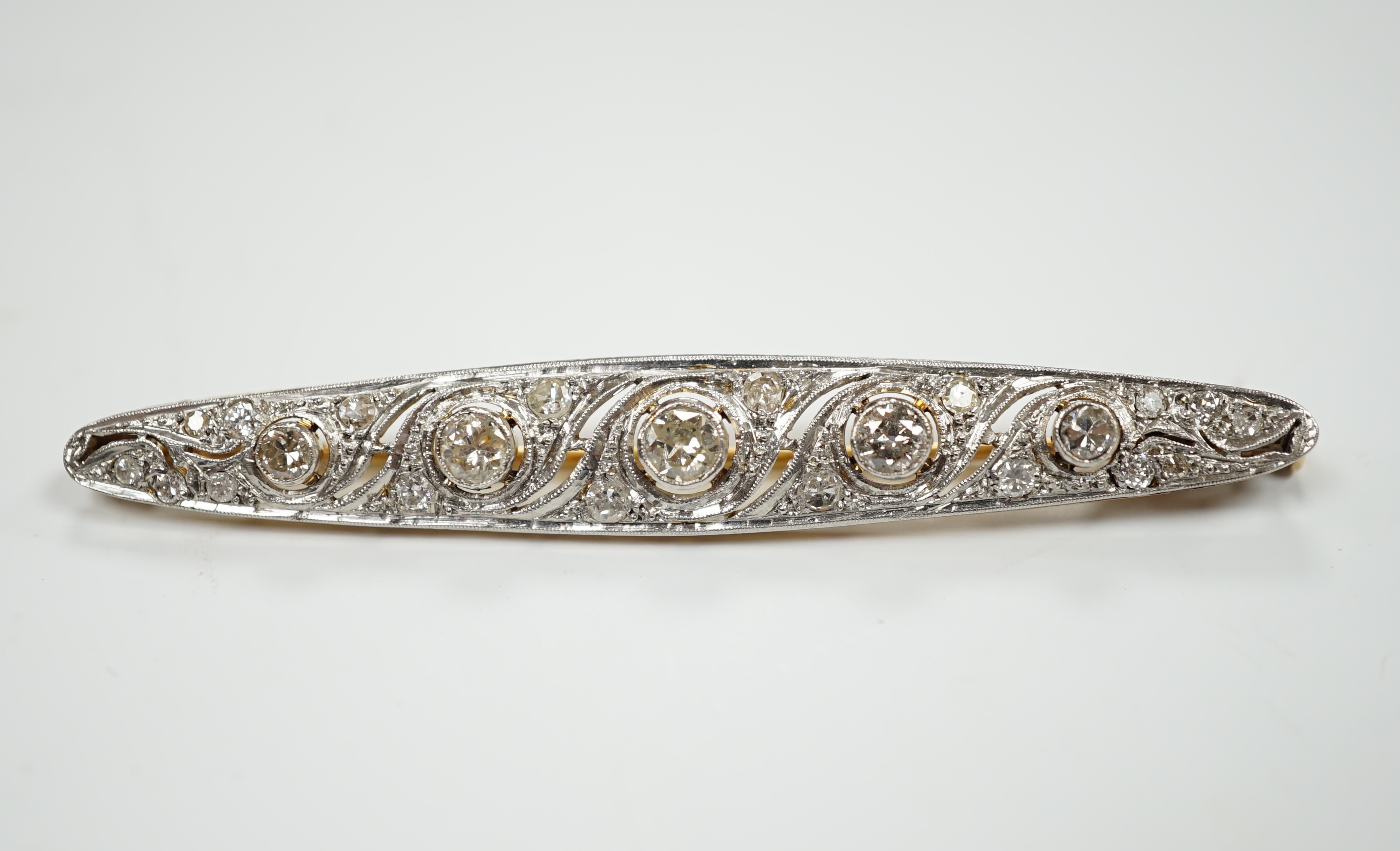 A Belle Epoque pierced white and yellow metal, diamond cluster set navette shaped bar brooch, 62mm, gross weight 5.5 grams.